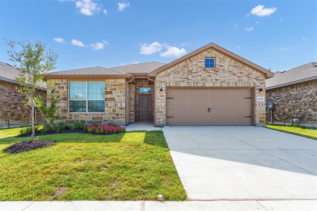 14621 Bootes Drive Haslet, TX 76052 - Photo 1 of 40 View of front facade featuring driveway, stone siding, a front lawn, an attached garage, and a shingled roof