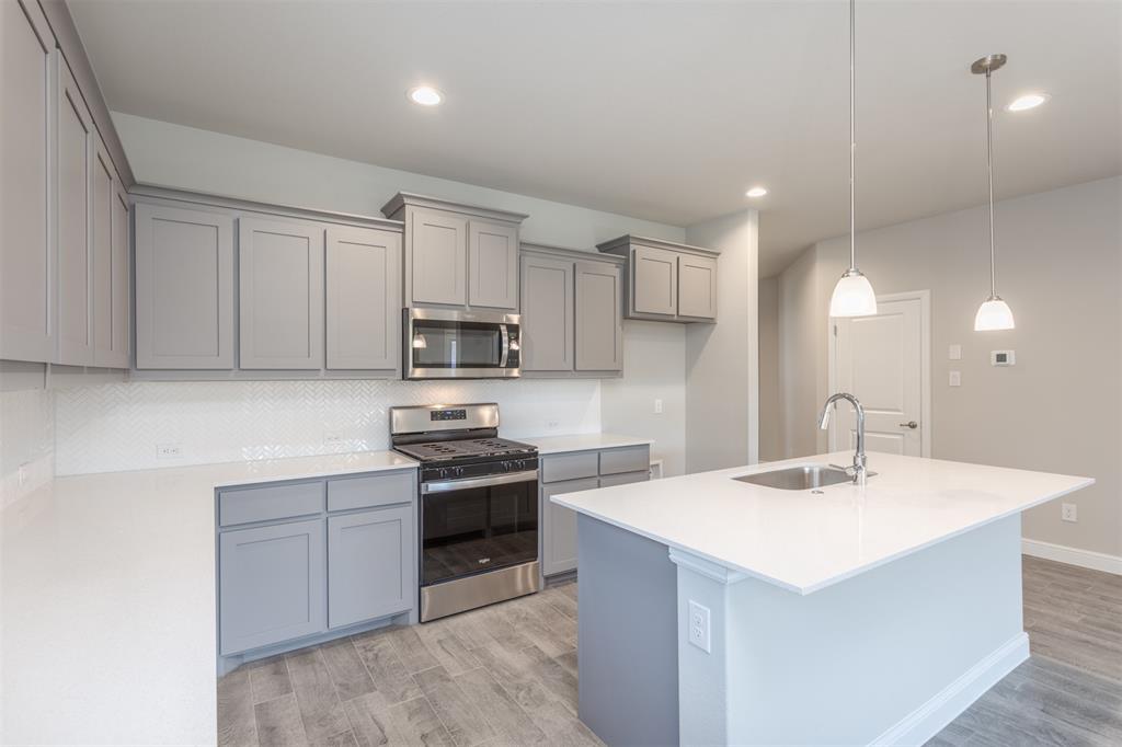14621 Bootes Drive Haslet, TX 76052 - Photo 19 of 40 Kitchen with gray cabinets, stainless steel appliances, light stone counters, and recessed lighting