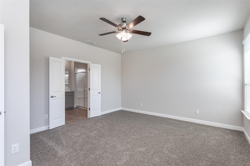 14621 Bootes Drive Haslet, TX 76052 - Photo 29 of 40 Unfurnished bedroom featuring carpet, ensuite bathroom, and a ceiling fan