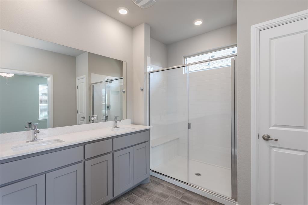 14621 Bootes Drive Haslet, TX 76052 - Photo 31 of 40 Bathroom featuring healthy amount of natural light, double vanity, a stall shower, wood finish floors, and recessed lighting