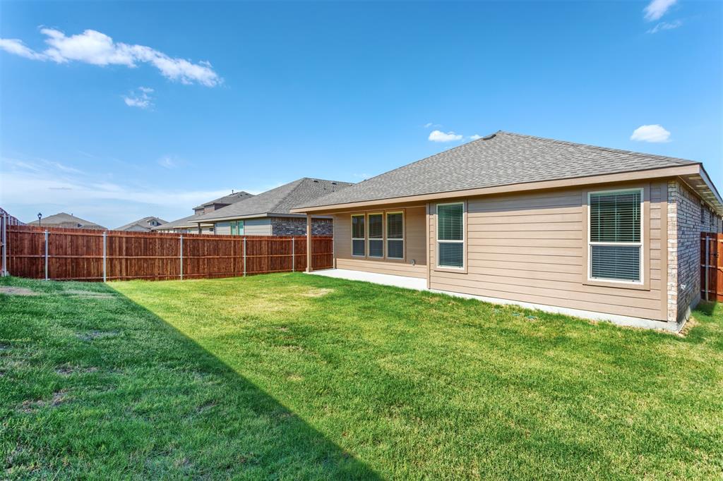 14621 Bootes Drive Haslet, TX 76052 - Photo 37 of 40 Back of house featuring a patio, a shingled roof, a fenced backyard, and brick siding