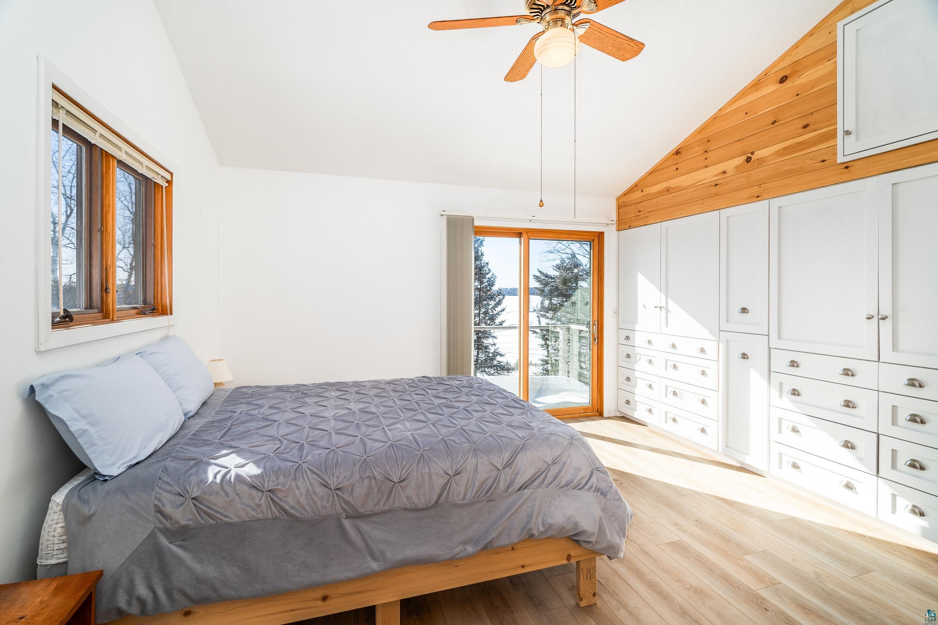 1480 Devil Track Road Grand Marais, MN 55604 - Photo 5 of 46 Bedroom with light hardwood / wood-style flooring, access to exterior, vaulted ceiling, and ceiling fan