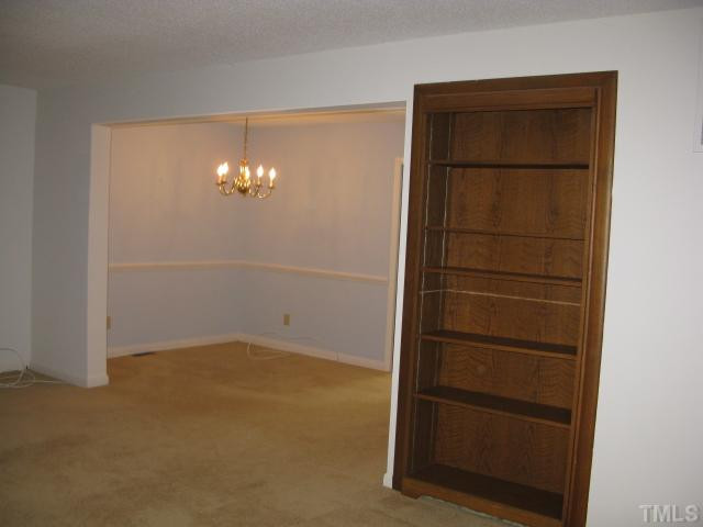 813 Green Ridge Drive Raleigh, NC 27609 - Photo 21 of 22 Open Floor Plan gives spacious feeling to Living Room with Built in Book case with adjustable shelves. Your Dining Room is accented with Chair Rail and has a convenient pocket door into your kitchen. Living Room