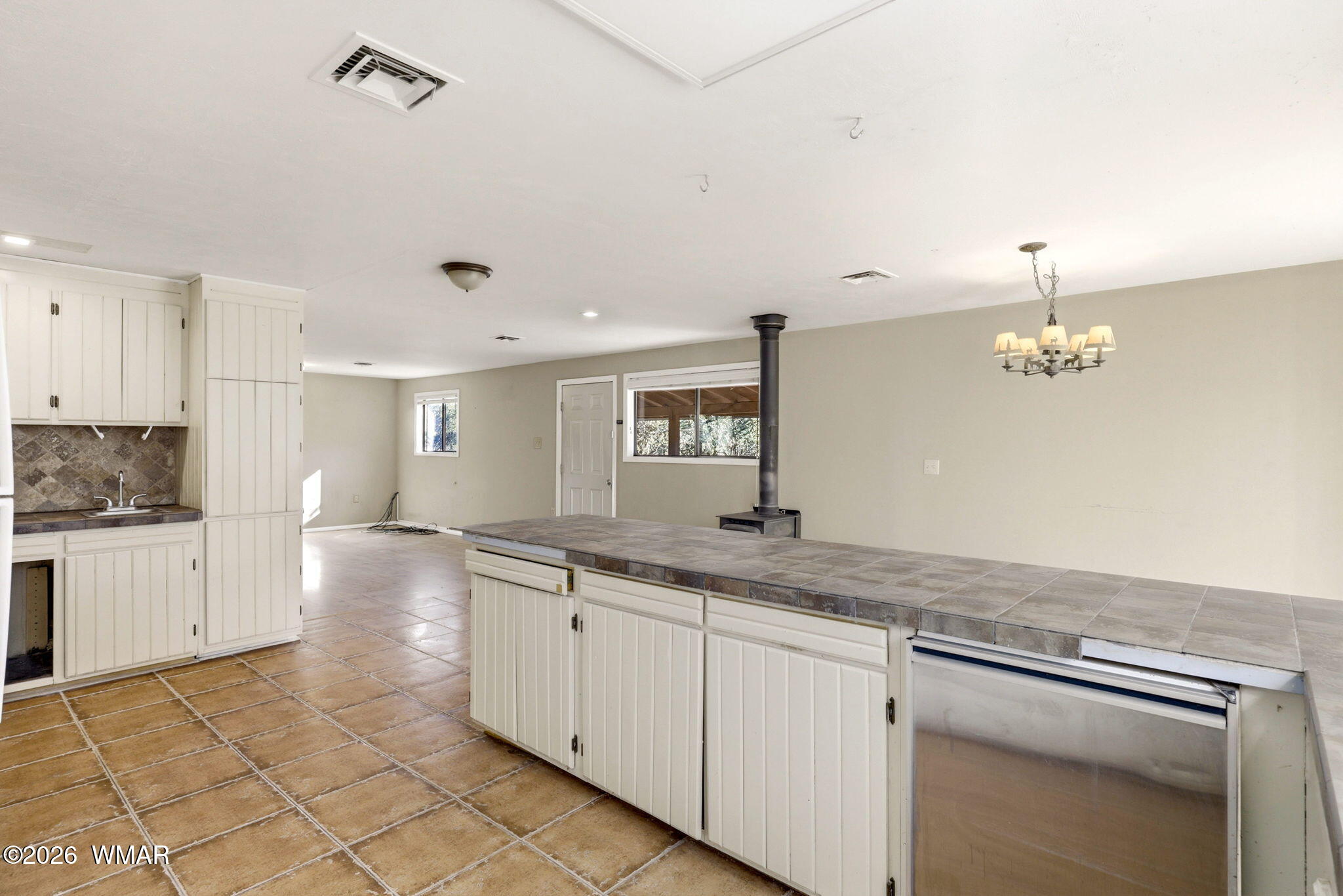 3650 Buckskin Road Overgaard, AZ 85933 - Photo 12 of 33 a kitchen with a sink refrigerator and cabinets