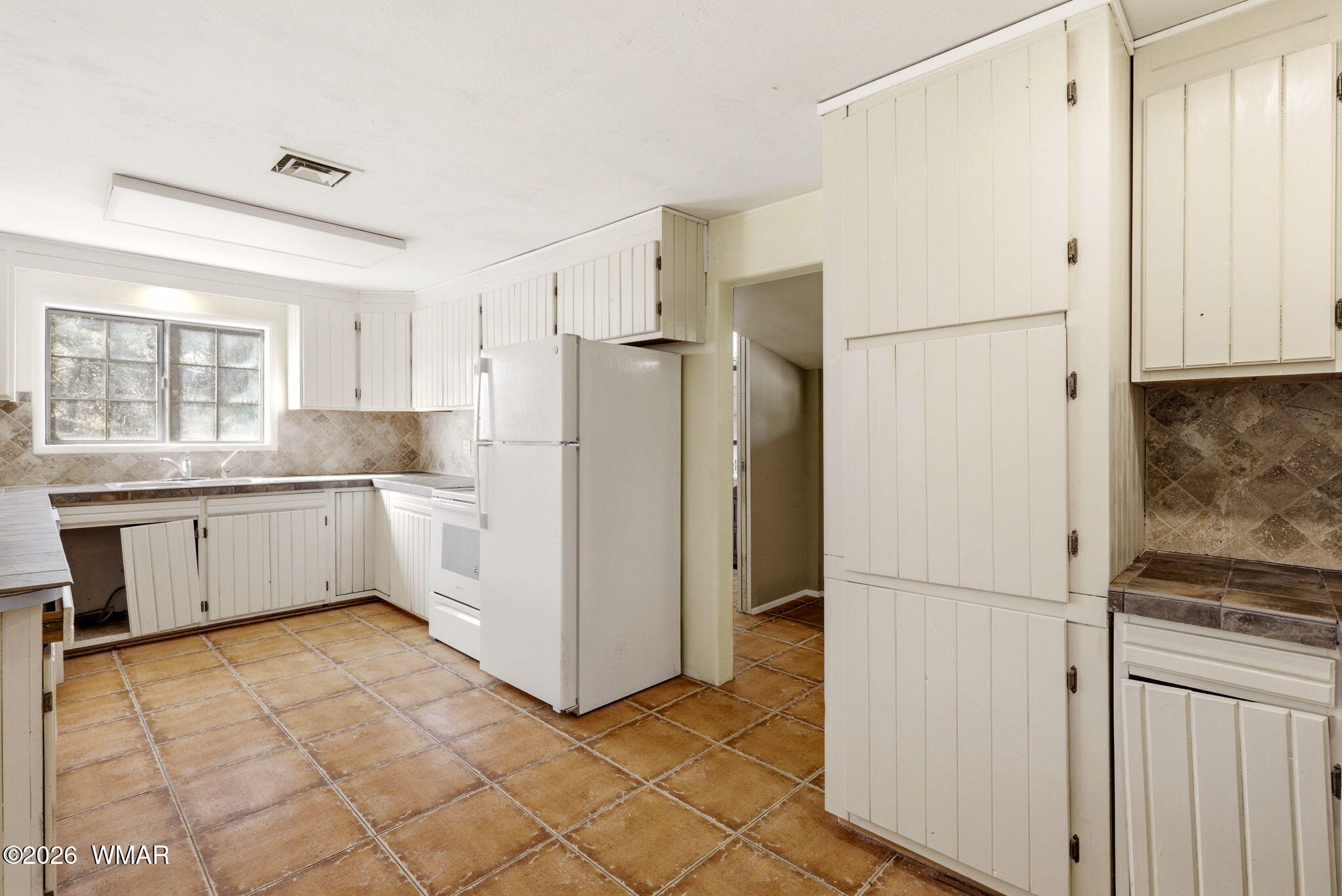 3650 Buckskin Road Overgaard, AZ 85933 - Photo 13 of 33 a kitchen with a refrigerator a sink and cabinets