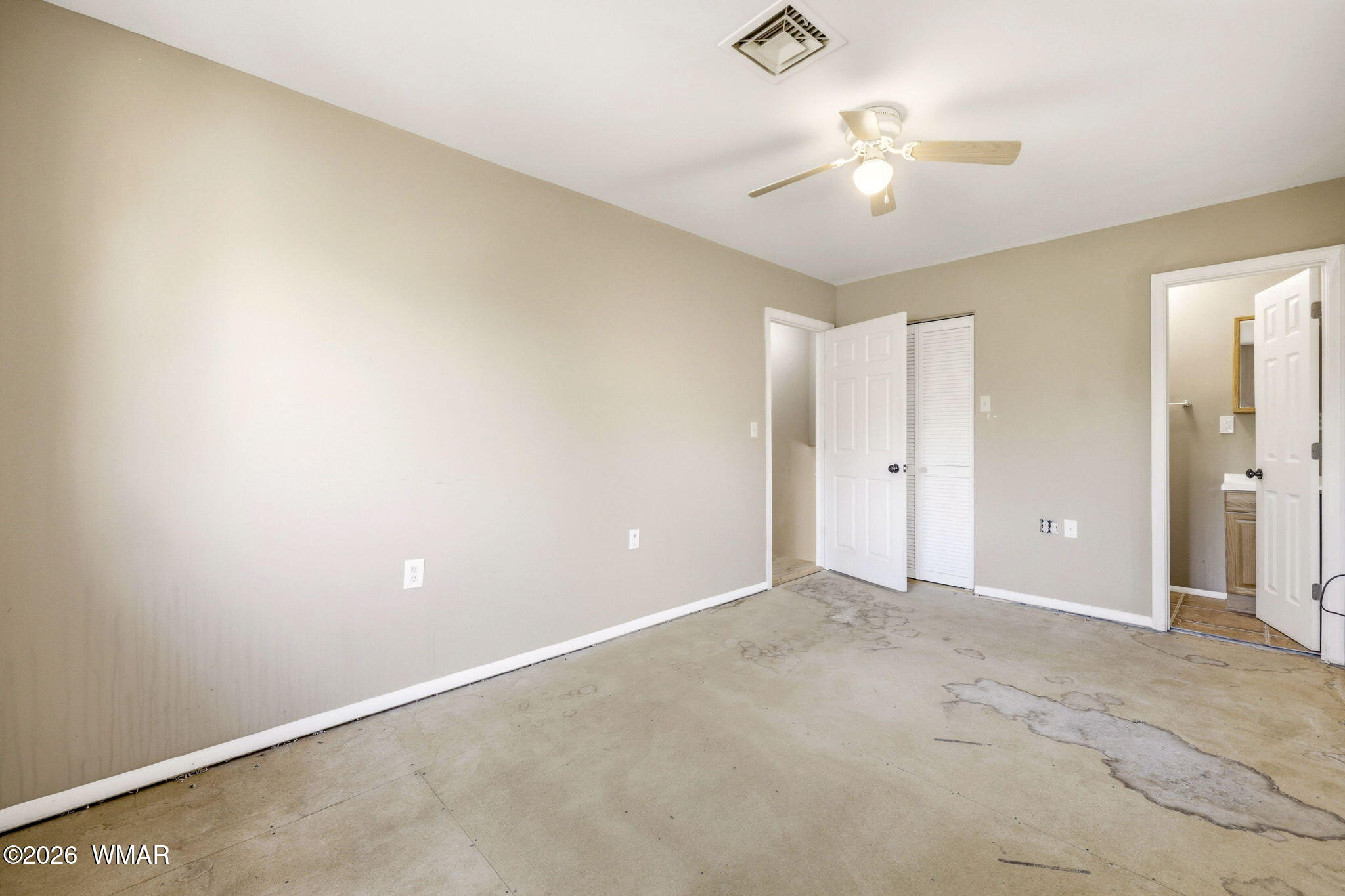 3650 Buckskin Road Overgaard, AZ 85933 - Photo 16 of 33 an empty room with a ceiling fan and a window