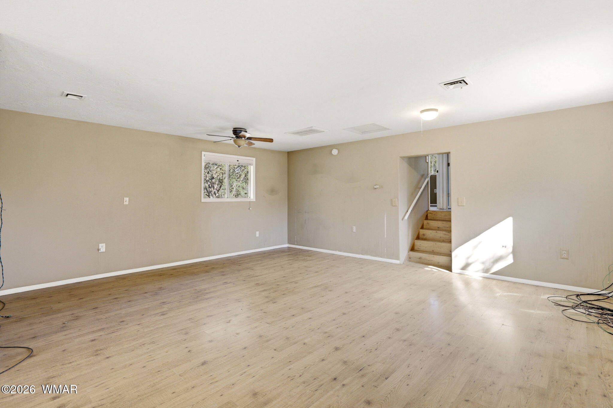 3650 Buckskin Road Overgaard, AZ 85933 - Photo 7 of 33 an empty room with wooden floor and windows