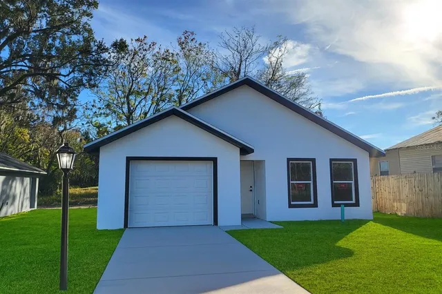 a front view of house with yard and green space
