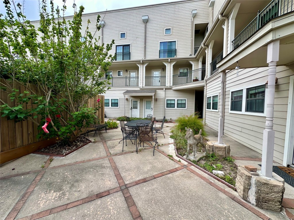 1602 Elgin Street, Unit 13 Houston, TX 77004 - Photo 19 of 22 a view of a building with a yard and sitting area