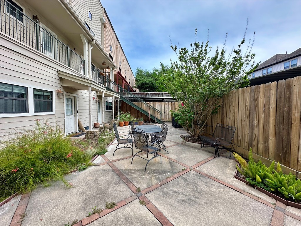 1602 Elgin Street, Unit 13 Houston, TX 77004 - Photo 21 of 22 a view of a patio with table and chairs and potted plants