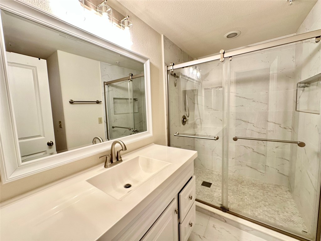 1602 Elgin Street, Unit 13 Houston, TX 77004 - Photo 8 of 22 a bathroom with a shower sink and mirror