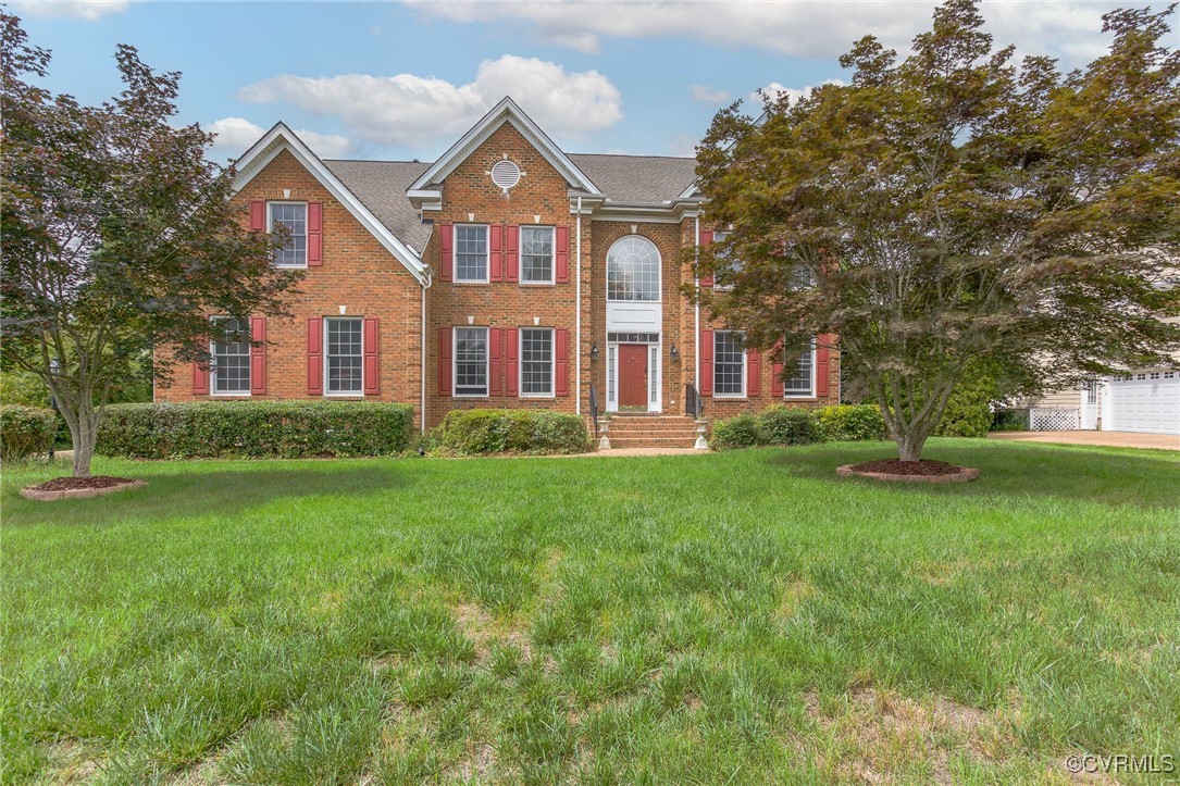 1306 Bach Terrace Midlothian, VA 23114 - Photo 1 of 50 a front view of a house with a yard and trees