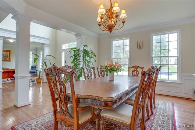 a view of a dining room with furniture window and wooden floor