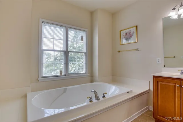 a bathroom with a bathtub and a window