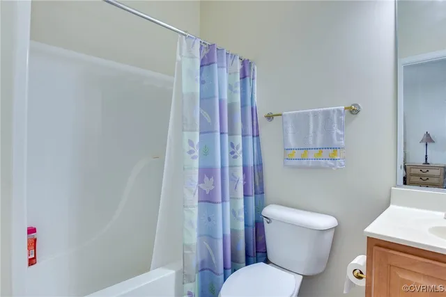 a white toilet sitting next to a bathroom sink