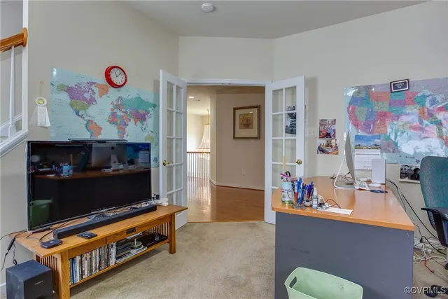 a living room with furniture toys and a flat screen tv