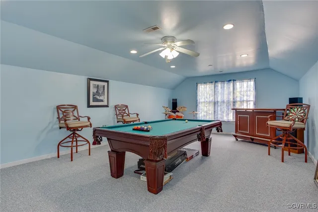 a room with furniture pool table and windows