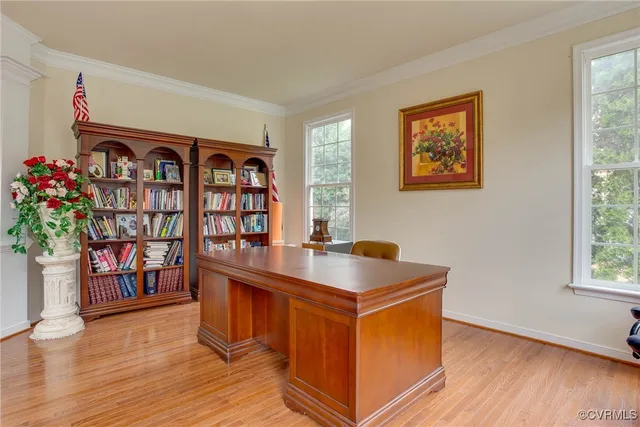 a view of a workspace with furniture and wooden floor