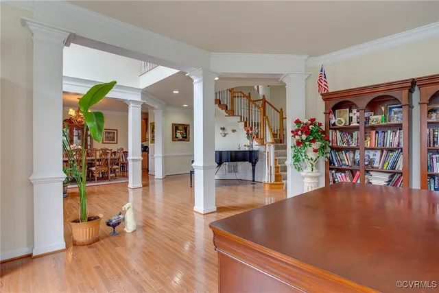 a living room with furniture and a book shelf