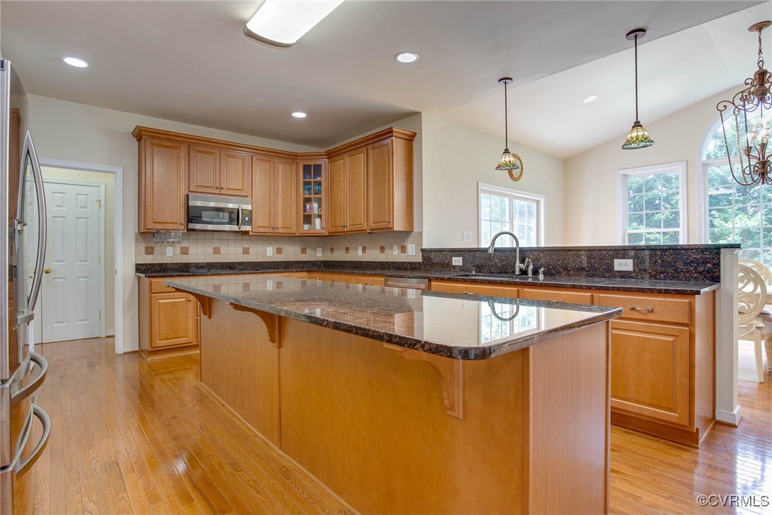 1306 Bach Terrace Midlothian, VA 23114 - Photo 9 of 50 a kitchen with kitchen island granite countertop wooden cabinets a sink and a stove
