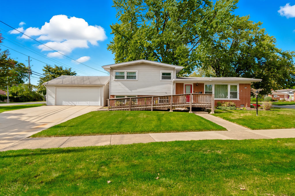178 West Normandy Drive Chicago Heights, IL 60411 - Photo 1 of 19 a front view of a house with a garden and yard