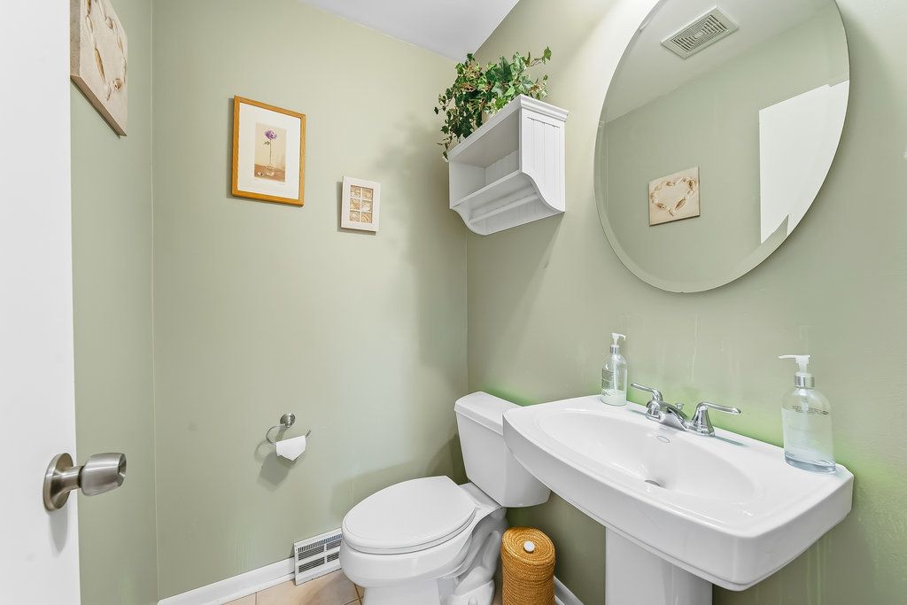 178 West Normandy Drive Chicago Heights, IL 60411 - Photo 11 of 19 a bathroom with a toilet a sink and mirror