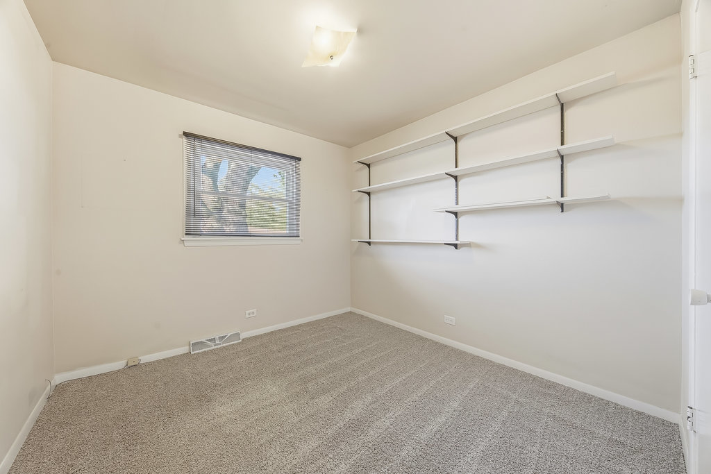 178 West Normandy Drive Chicago Heights, IL 60411 - Photo 13 of 19 an empty room with shelves on walls