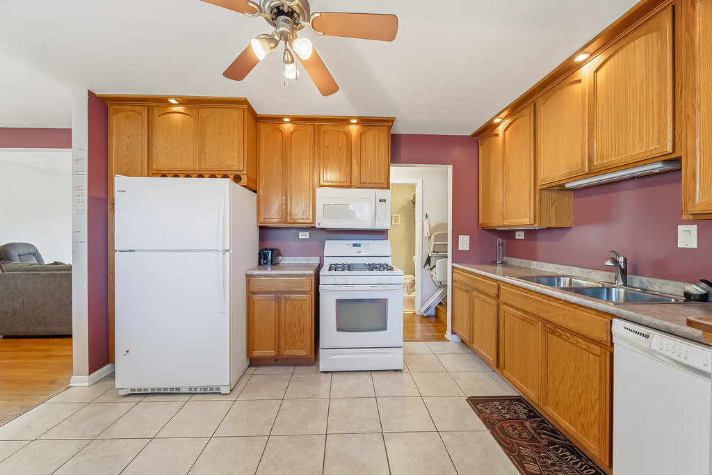 178 West Normandy Drive Chicago Heights, IL 60411 - Photo 8 of 19 a kitchen with a refrigerator a stove top oven and cabinets