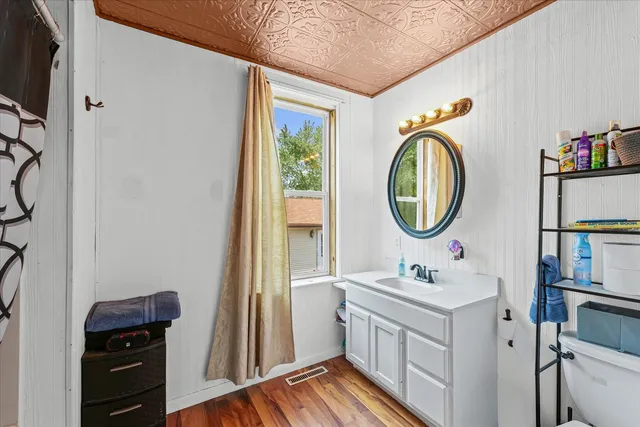 a bathroom with a sink a mirror and a window