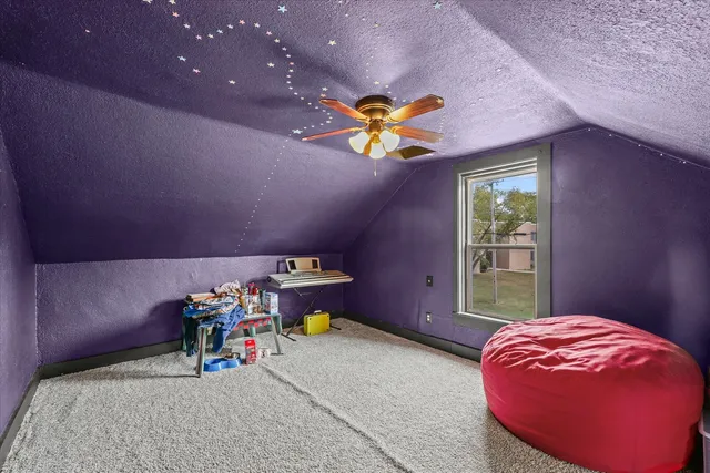 a bed room with a bed and a chair