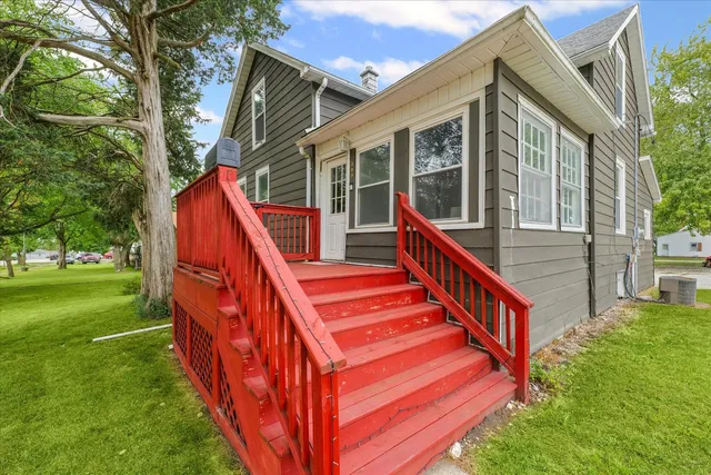 a view of an house with backyard and a house