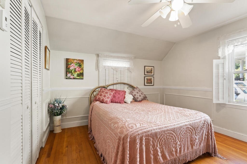 169 Ashcroft Road Medford, MA 02155 - Photo 21 of 33 a bedroom with a bed and a chandelier
