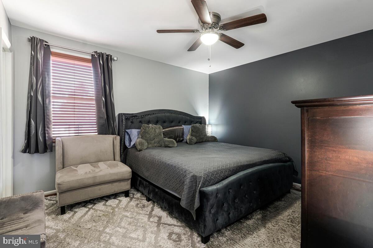 15937 Livingston Road Accokeek, MD 20607 - Photo 15 of 35 a bedroom with a bed couch and window