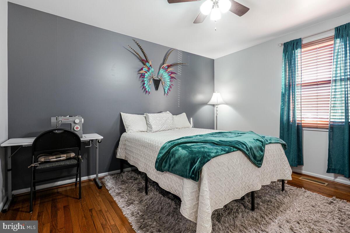 15937 Livingston Road Accokeek, MD 20607 - Photo 19 of 35 a bedroom with a bed and a chandelier