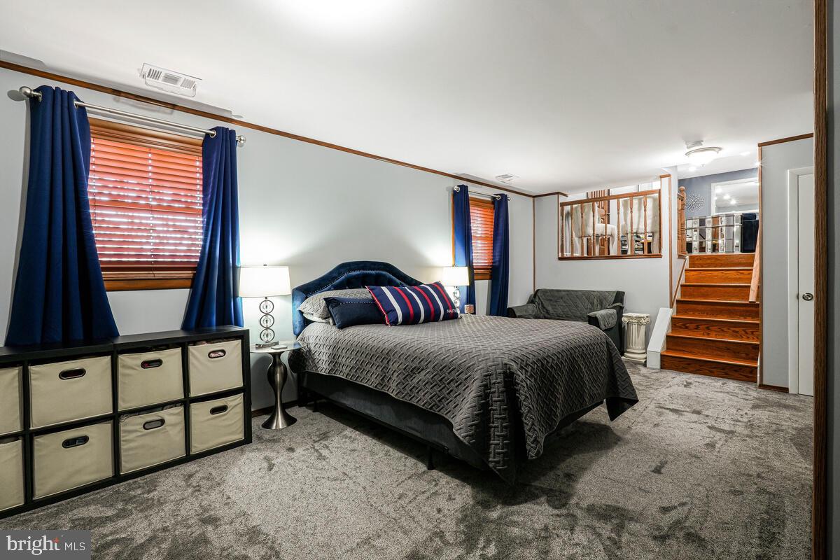 15937 Livingston Road Accokeek, MD 20607 - Photo 26 of 35 a bedroom with a bed and a dresser with the shoe rack