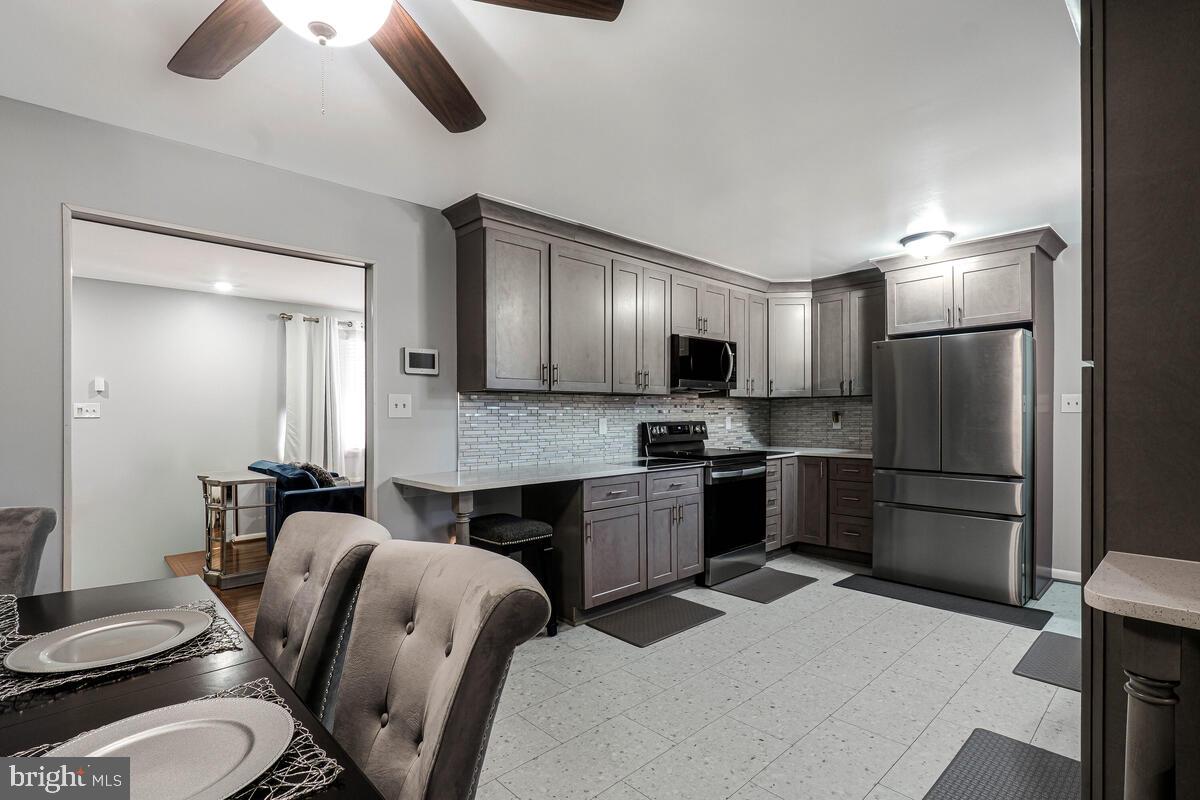 15937 Livingston Road Accokeek, MD 20607 - Photo 8 of 35 a kitchen with stainless steel appliances granite countertop a refrigerator a stove top oven a sink and dishwasher