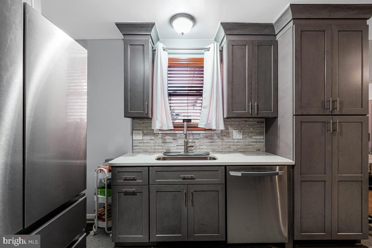 15937 Livingston Road Accokeek, MD 20607 - Photo 10 of 35 a kitchen with a refrigerator and a sink