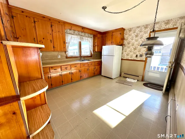 a kitchen with refrigerator and window