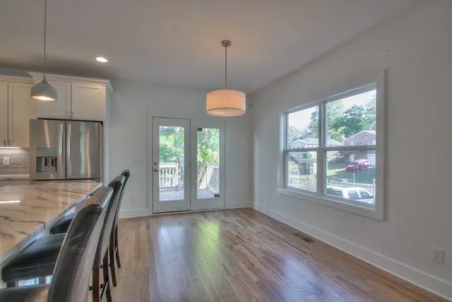 a view of a dining room with furniture window and wooden floor