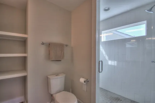 a white toilet sitting next to a bathroom sink