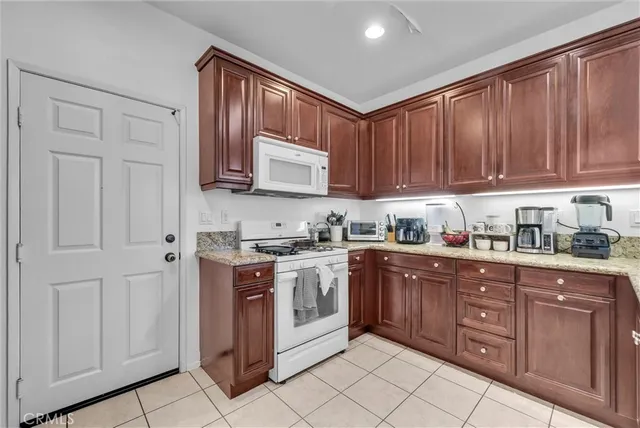 a kitchen with stainless steel appliances granite countertop a stove and cabinets