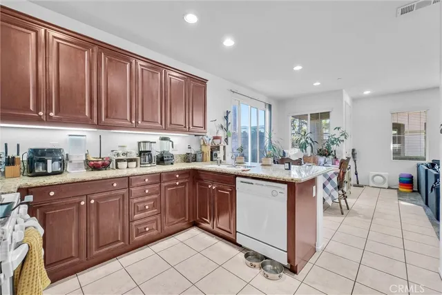 a kitchen with stainless steel appliances granite countertop a sink and cabinets