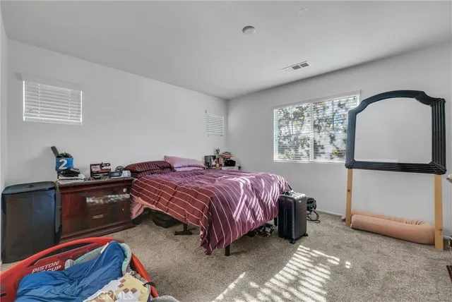 a bed room with a bed and a television