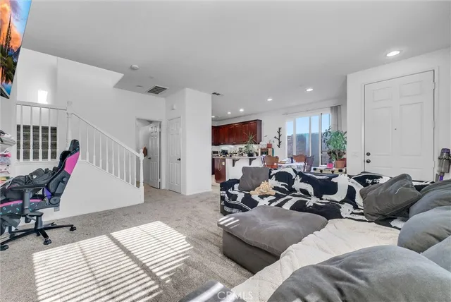 a living room with furniture gym equipment and a view of kitchen