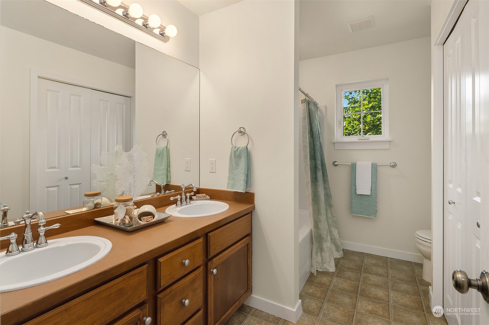 16529 38th Avenue Southeast Bothell, WA 98012 - Photo 31 of 40 a bathroom with a granite countertop sink and a mirror
