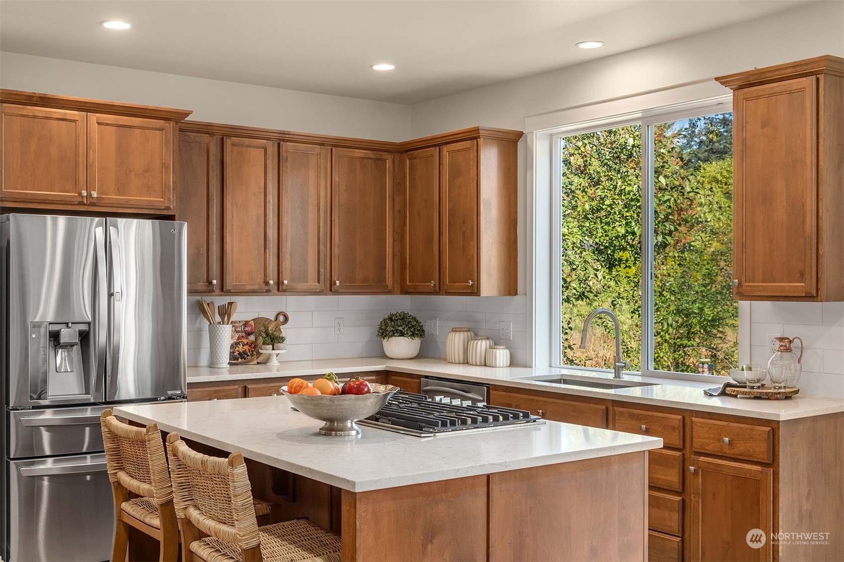 16529 38th Avenue Southeast Bothell, WA 98012 - Photo 10 of 40 a kitchen with stainless steel appliances granite countertop a stove a sink dishwasher and a refrigerator with wooden cabinets
