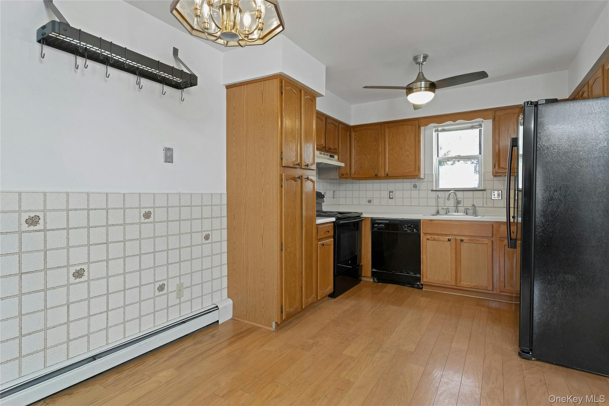 6 Elm Court Fishkill, NY 12524 - Photo 7 of 18 a view of a kitchen with a sink and dishwasher a refrigerator with wooden floor