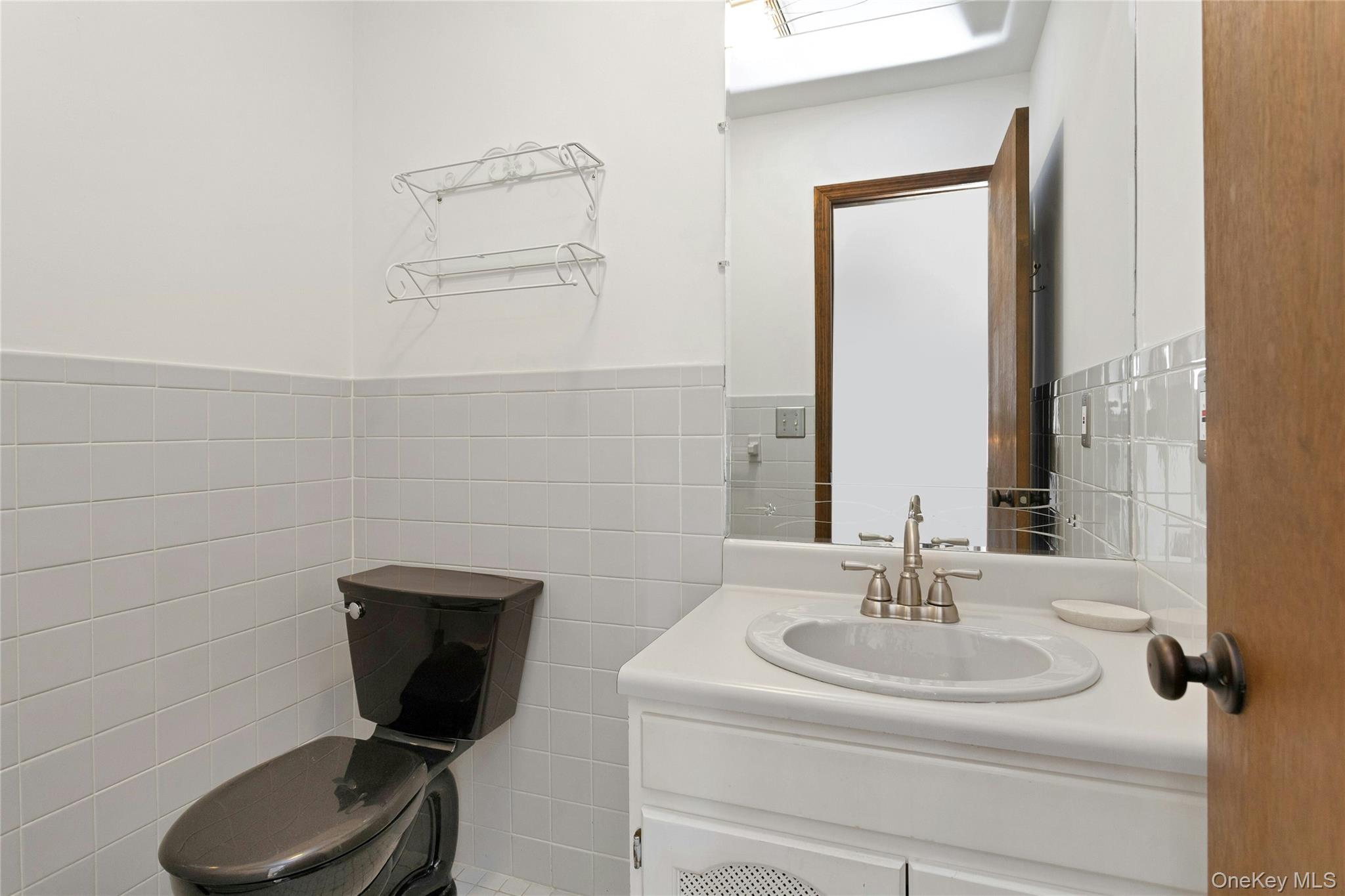 6 Elm Court Fishkill, NY 12524 - Photo 10 of 18 a bathroom with a sink and a mirror