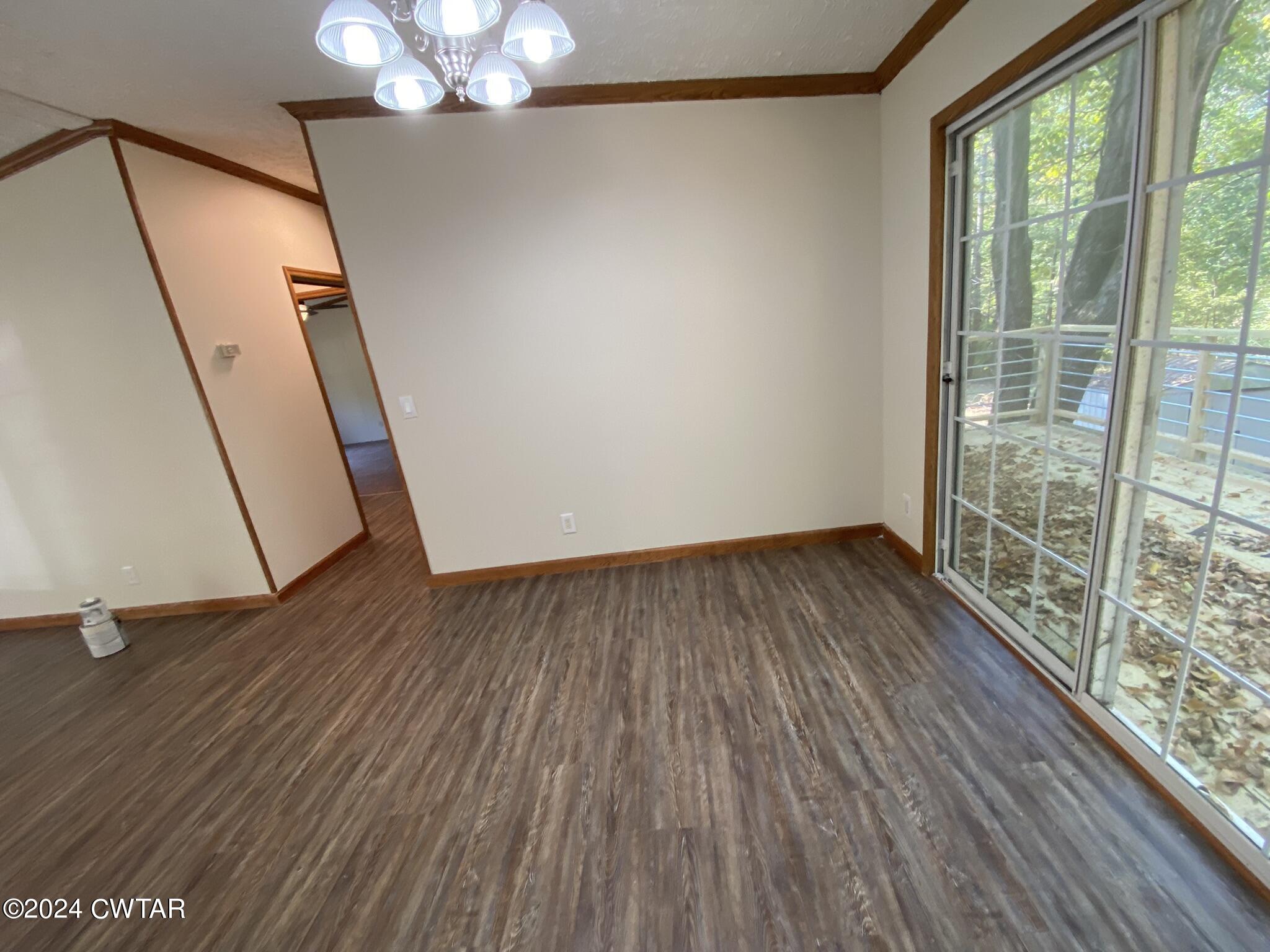 6555 Roby Road Enville, TN 38332 - Photo 4 of 22 a view of empty room with wooden floor and fan
