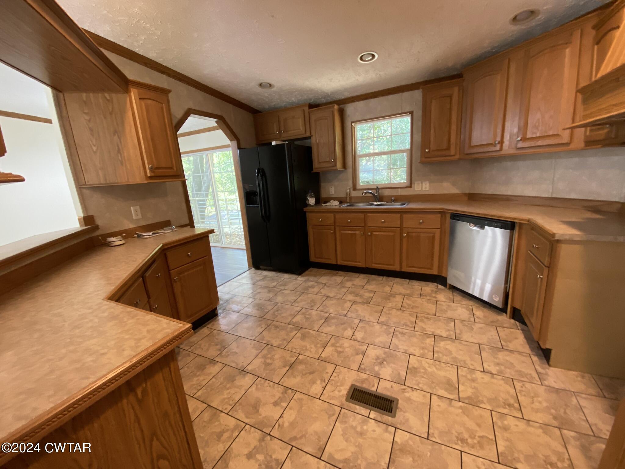 6555 Roby Road Enville, TN 38332 - Photo 8 of 22 a kitchen with a sink a window and appliances